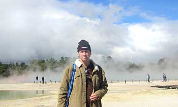 Ian standing in front of the Champagne Pool, as clouds of steam roll across in the background.