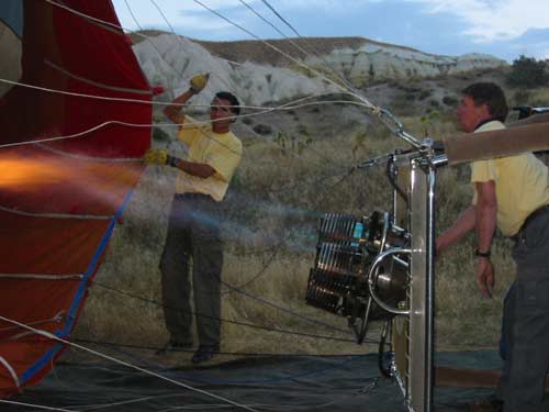 Ground crew begin filling the balloons with hot air