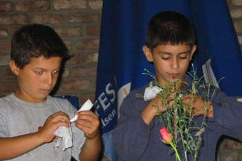 Boys practising making paper flowers