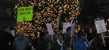 Man carrying placard that reads 'Jesus Loves You'