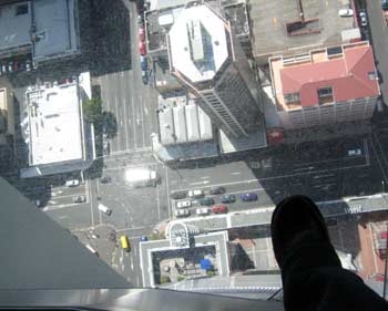 Manda's foot on a glass floor panel in Sky Tower, 186 metres above the streets below