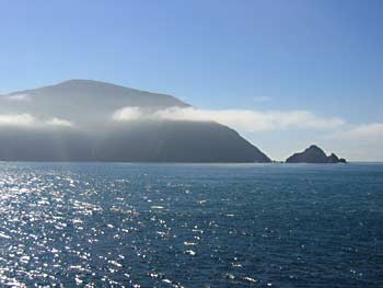 The first signs of South Island, capped with light cloud.