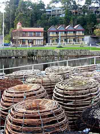 Crayfish cages stacked up on a fishing boat moored in the harbour at Strahan .