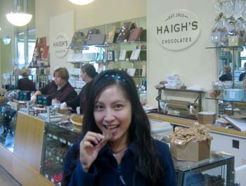 Manda biting into some Haigh's chocolate honeycomb block.